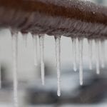 A photo of icicles hanging off of frozen pipes, a condition that may require an emergency plumber.
