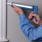 Applying caulk to windows